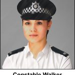 A watercolour painting of an attractive British police officer aged about 25 years old, looking smart and authoritative in her summer uniform. She is wearing a peaked cap with a chequered band, and a silver badge depicting a wolf's head. White blouse, no tie, and black epaulettes with silver numerals saying 49. She has simple silver stud earrings. The image is labelled Constable Walker.