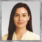 A watercolour painting of Aunt Sylvie, the Governess of the Noble Coliseum, smiling without parting her lips. Aged about 30, she has beautiful, long, hazel brown hair and light chestnut brown eyes. She is wearing a simple pale yellow blouse, light cosmetics, no jewellery not even earrings, allowing her natural beauty to stand out. The images is labelled AuntSylvie.