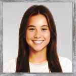 A watercolour painting of an attractive young girl aged 16. She has gorgeous long medium ash brown hair and her eyes are dark chestnut brown. Her face has a picture perfect smile revealing lovely white teeth. She is wearing a plain white T shirt (and blue jeans out of shot).