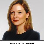 A watercolour painting of pretty 40 year old lady with dark caramel blonde hair reaching to the top of her shoulders. Her eyes are a dark chestnut colour, and she has a soft glowing complexion which matches her natural smile. She's wearing a casual woollen top in navy blue, and has tiny gold stud earrings.