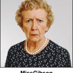 A watercolour painting of a 73 year old lady with short golden blonde curly hair with traces of grey. Mel Gibson lives in a retirement home and suffers from dementia. Her eyes are brown and she has a confused expression. She is wearing a navy blue dress with a simple printed pattern of white leaves. She wears a necklace which is a single line of pearls, but no earrings. The image is labelled MissGibson.