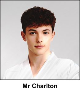 A watercolour painting of school teacher Bob Charlton from the PE department. He’s 24 years old and his brown hair has a curly textured fringe with tapered sides. His deep rich brown eyes make him look quite attractive and he has an almost imperceptible smile. He’s wearing a bright red tie, a white shirt and a black suit jacket. The image is labelled Mr Charlton.